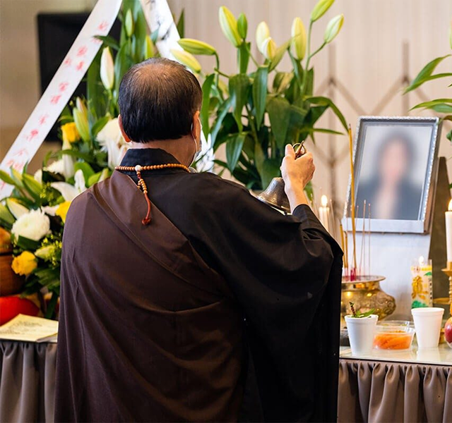 buddhist monk conducting memorial service